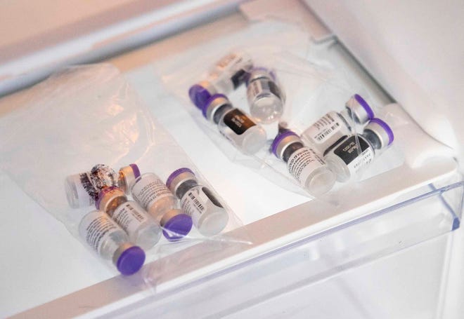 Bottles of the Pfizer Covid-19 vaccine are cooled in a refrigerator before being given to patients. The downtown Panama City marina had people lined up for the first of three days of Covid-19 vaccinations Tuesday, March 16, 2021. 