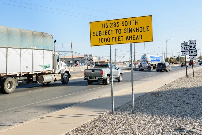 Signs in Carlsbad warn of a possible sinkhole, caused by a brine well.