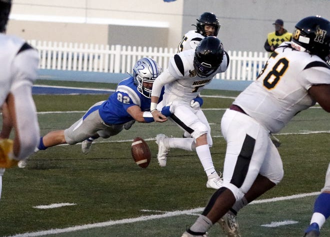 Carlsbad's Austin Blair strip sacks Hobbs' Colton Graham in the first quarter of their game on March 19, 2021. Carlsbad's defense forced six turnovers and won, 27-21.