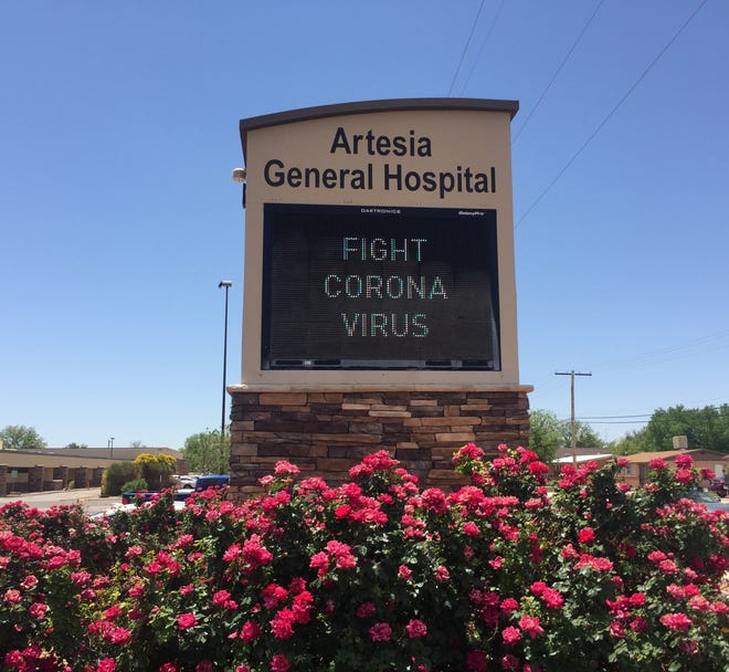 A sign at Artesia General Hospital reminds people to fight COVID-19 on May 14, 2021 the State of New Mexico followed CDC guidelines allowing people fully vaccinated against COVID-19 not to wear masks for indoor and outdoor public settings.