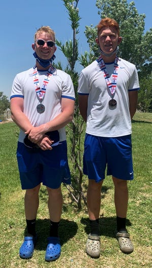 Carlsbad's Andrew Miller, left, and Clayton Bluth, right, display their 2nd place medals won at the 5A boys tennis doubles championship on June 12, 2021.