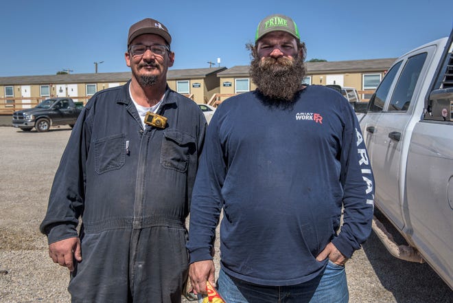 Gas and oil workers Daniel Roberson (left) and Brandon Moss, both of whom had been laid off for six to seven months during the pandemic. "Hiring has started again," Moss said. "It's always up and down in this business."