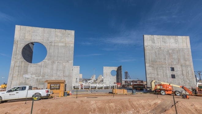 The shear, or supporting, walls of WIPP’s Salt Reduction Building rise 41 feet in anticipation of the arrival of tilt-up prefabricated walls that will attach to the shear walls. The round holes in the shear walls are for inbound and outbound air from WIPP’s underground.