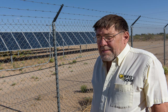 Nick King, a member of Citizens Caring for the Future's leadership team, stands in front of Carlsbad's Hopi Substation, a ten megawatt solar array that feeds power to the electric grid.