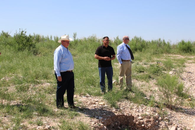 From left: City of Carlsbad Deputy City Administrator KC Cass, Lt. Gov. Howie Morales and Scott Hicks of Smith Engineering survey damage from June floods in Carlsbad on July 9, 2021.