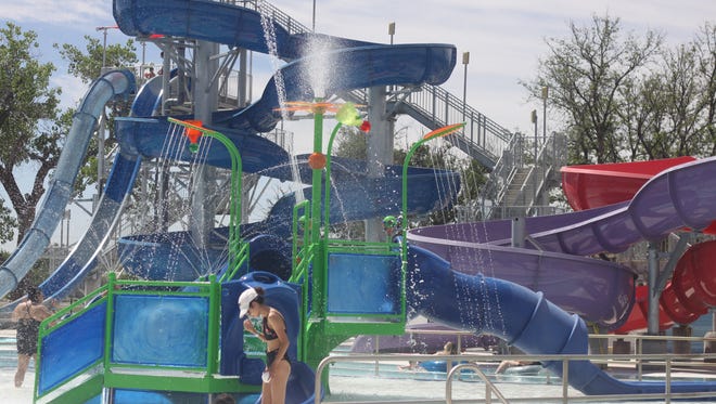 Children from Carlsbad and the surrounding areas cool down in the pools and slides of the Carlsbad Water Park, during the grand opening, May 26, 2018 on Park Drive.