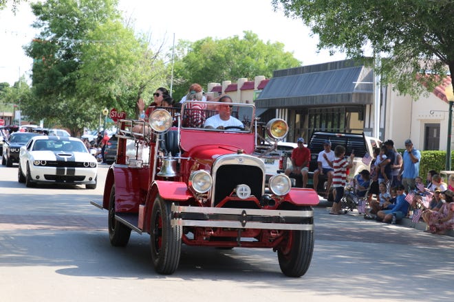 Carlsbad Fire Chief Richard Lopez drives an antique fire engine in Carlsbad's Independence Day parade on July 3, 2021.