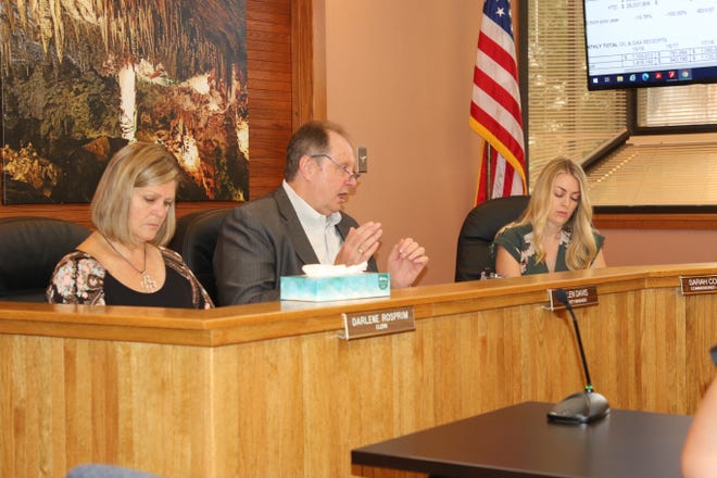 From left: Eddy County Clerk Darlene Rosprim, Eddy County Manager Allen Davis and District 5 Eddy County Commissioner Sarah Cordova listen to an update on May budget numbers on July 6, 2021.