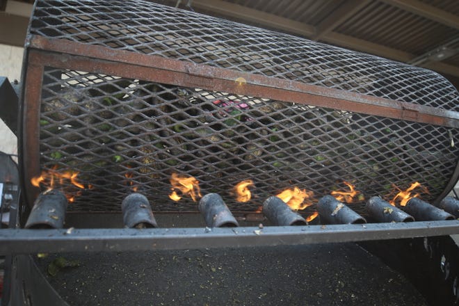 Hatch green chile peppers are roasted for customers, Aug. 6, 2021 at Albertsons in Carlsbad.