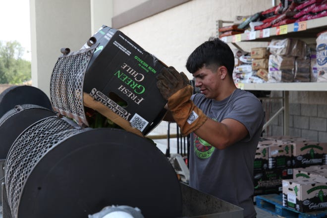 Hatch green chile peppers are roasted for customers, Aug. 6, 2021 at Albertsons in Carlsbad.