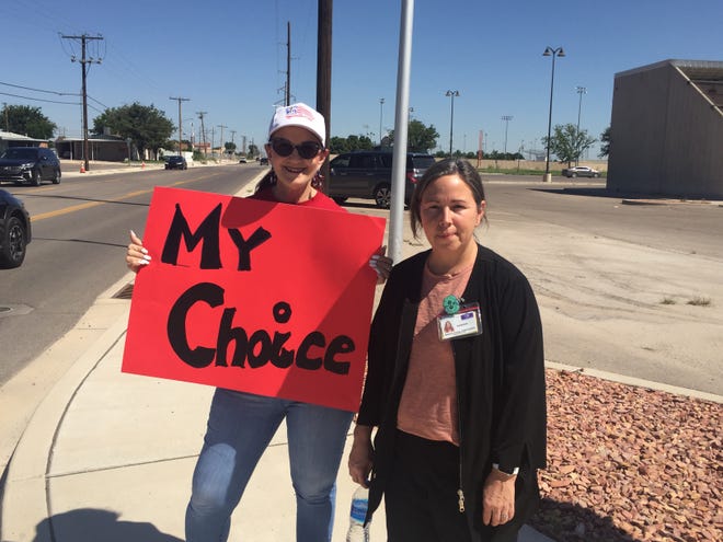 Selah Perkins, left, and Vanessa Harvey protest in Artesia on Wednesday, Aug. 25, 2021 against mandates from Gov. Michelle Lujan Grisham ordering healthcare workers to receive COVID-19 shots.