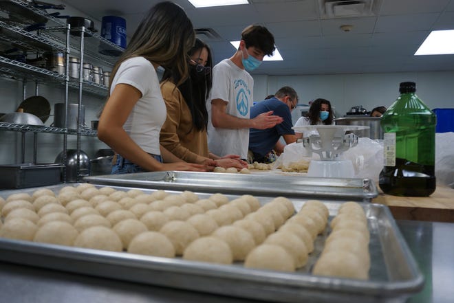 Students from the Carlsbad High School culinary program make break rolls for their Meals To Go program.